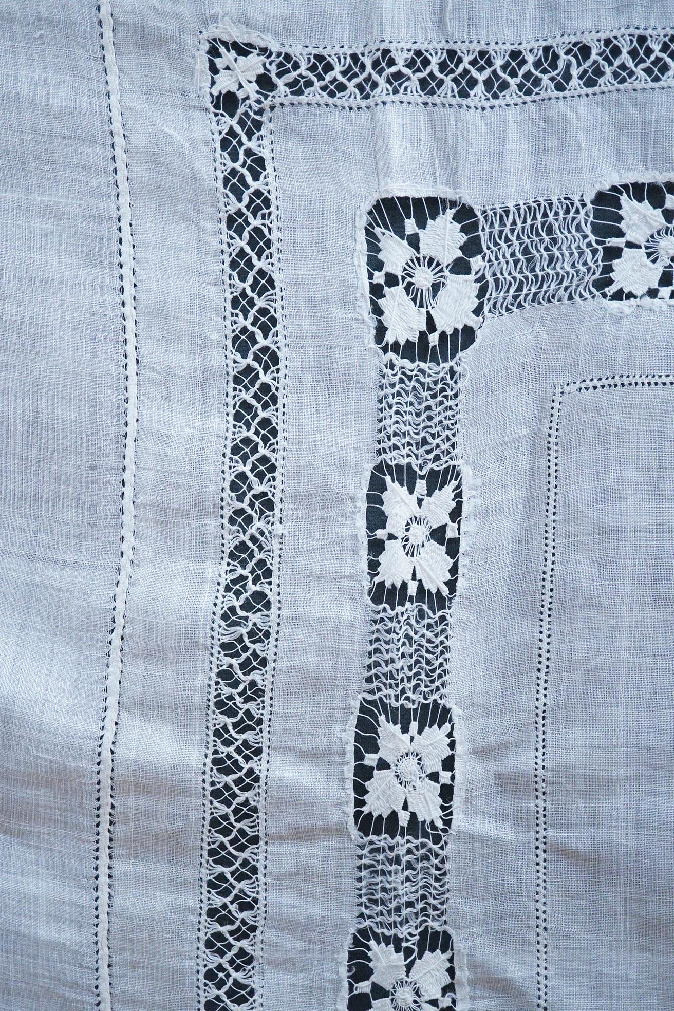 An ornate pineapple linen table cloth - 220cm x 190cm and a similar tea cosy, together with a collection of crochet edged, embroidered and cutwork table linens.